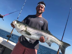 Guy with a striped bass he caught